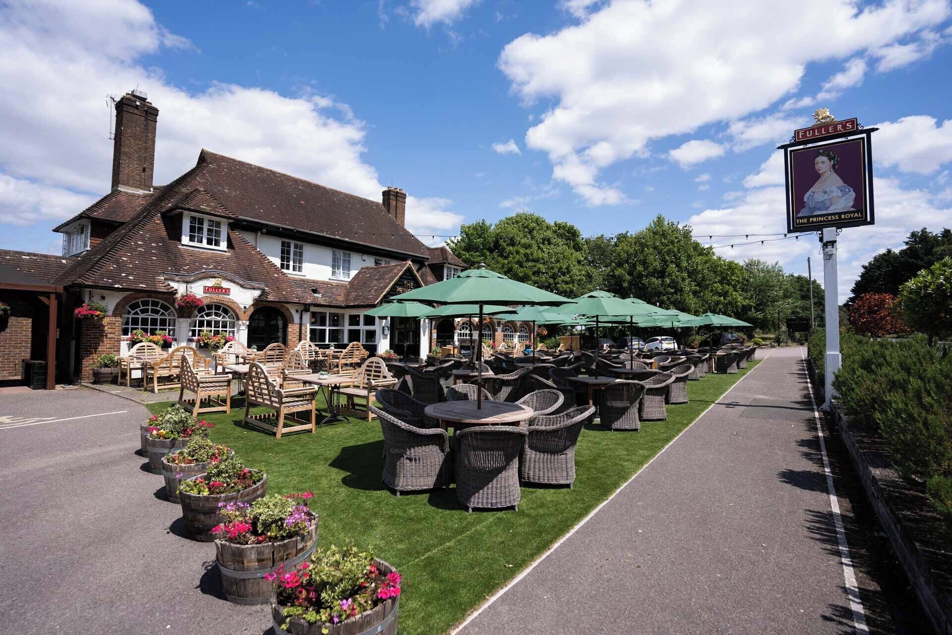 A traditional pub with outdoor seating and a sign reading "The Princess Royal".