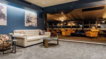A lounge area with a sofa, armchairs, and a coffee table.