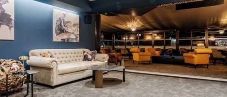 A lounge area with a sofa, armchairs, and a coffee table.