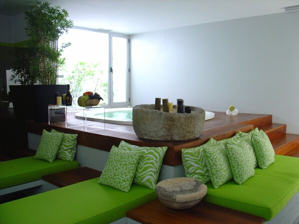 A modern living room with green sofas and a stone bowl. - Convento dos Capuchos (Monção)