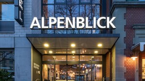 The exterior of the Alpenblick hotel with a modern glass facade, a visible entrance, and a clear view of the surrounding buildings. - Alpenblick Bern (Bern)