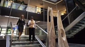 A modern building with a glass atrium, a staircase, and abstract sculptures. - Novotel Buenos Aires (Buenos Aires)