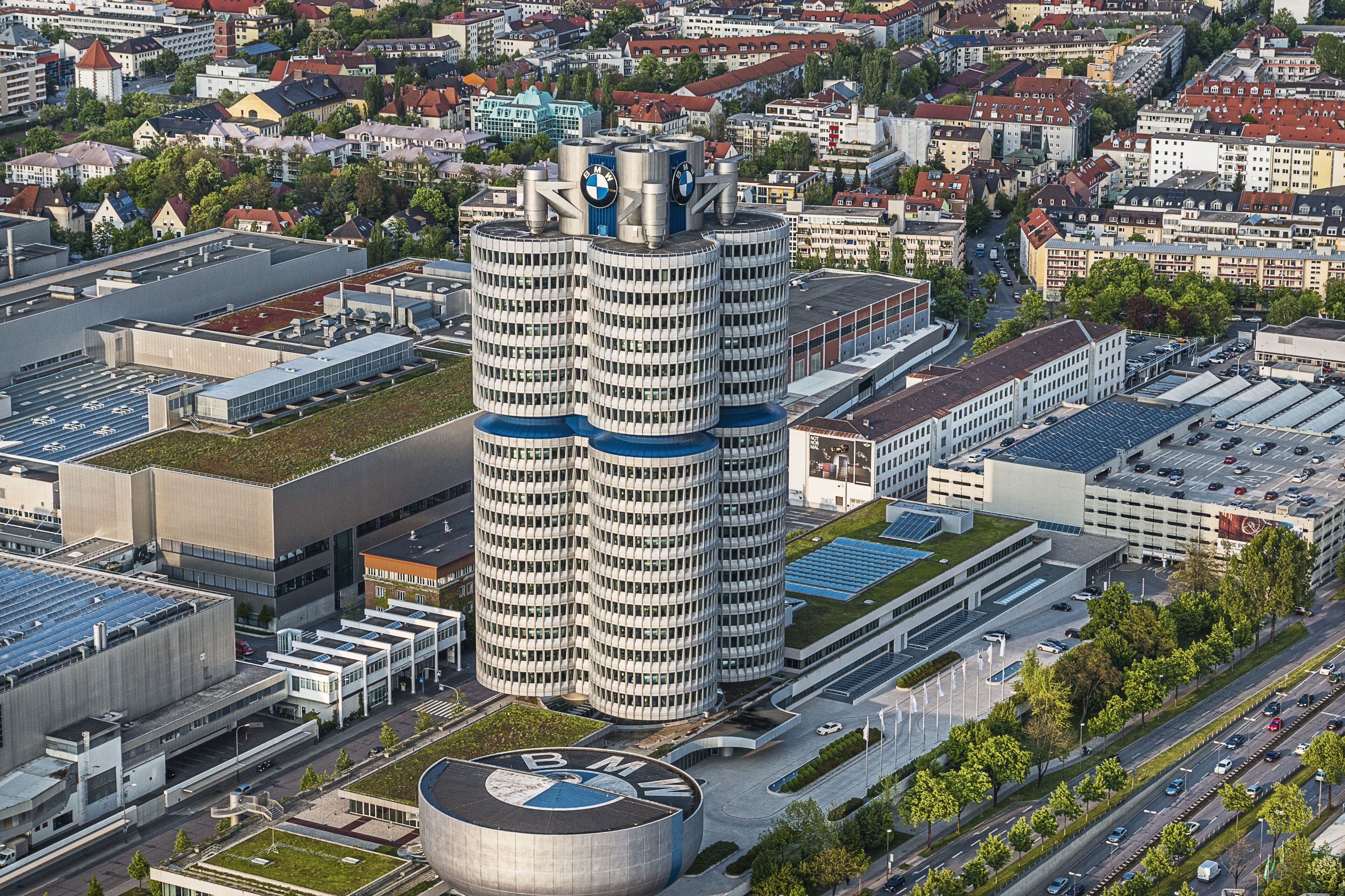 Un immeuble de grande hauteur avec un toit circulaire et le logo de BMW.
