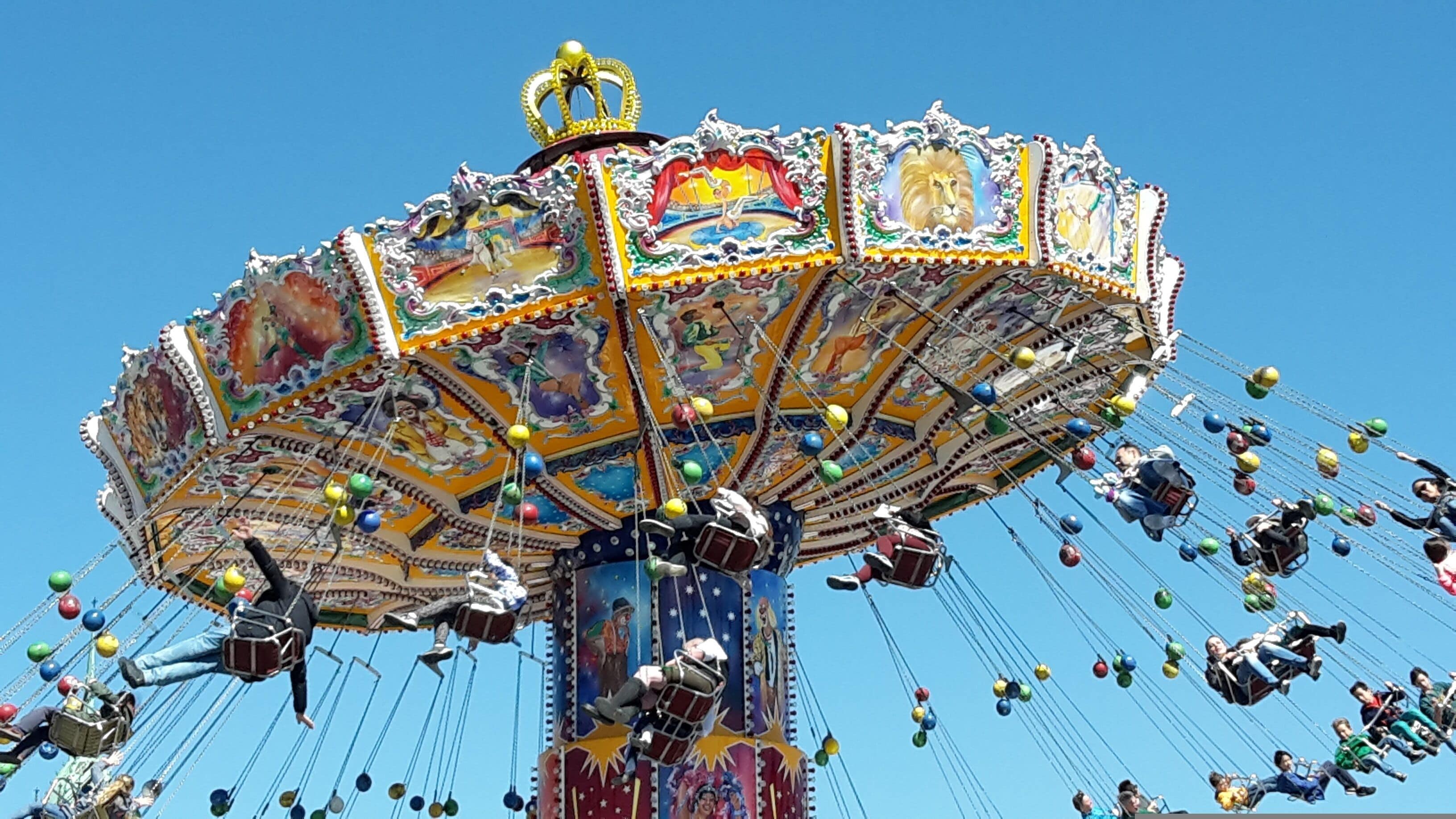 A carousel with colorful decorations and a central pole.