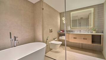 A modern bathroom with a freestanding bathtub, a walk-in shower, and a vanity with a large mirror.