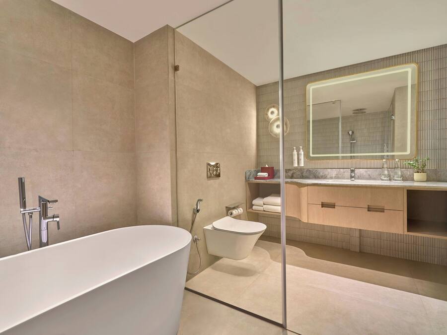 A modern bathroom with a freestanding bathtub, a walk-in shower, and a vanity with a large mirror.