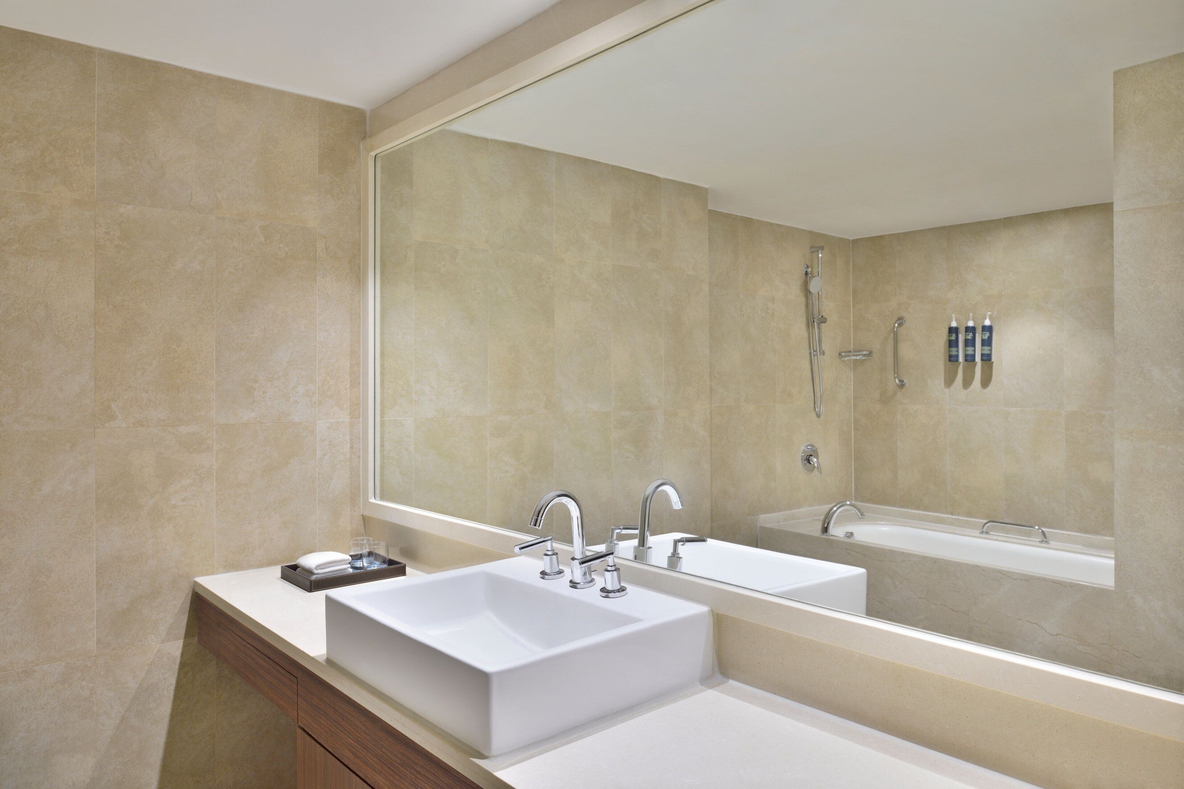 executive suite, 1 king bed, non smoking, city view | bathroom | free toiletries, hair dryer, slippers, towels