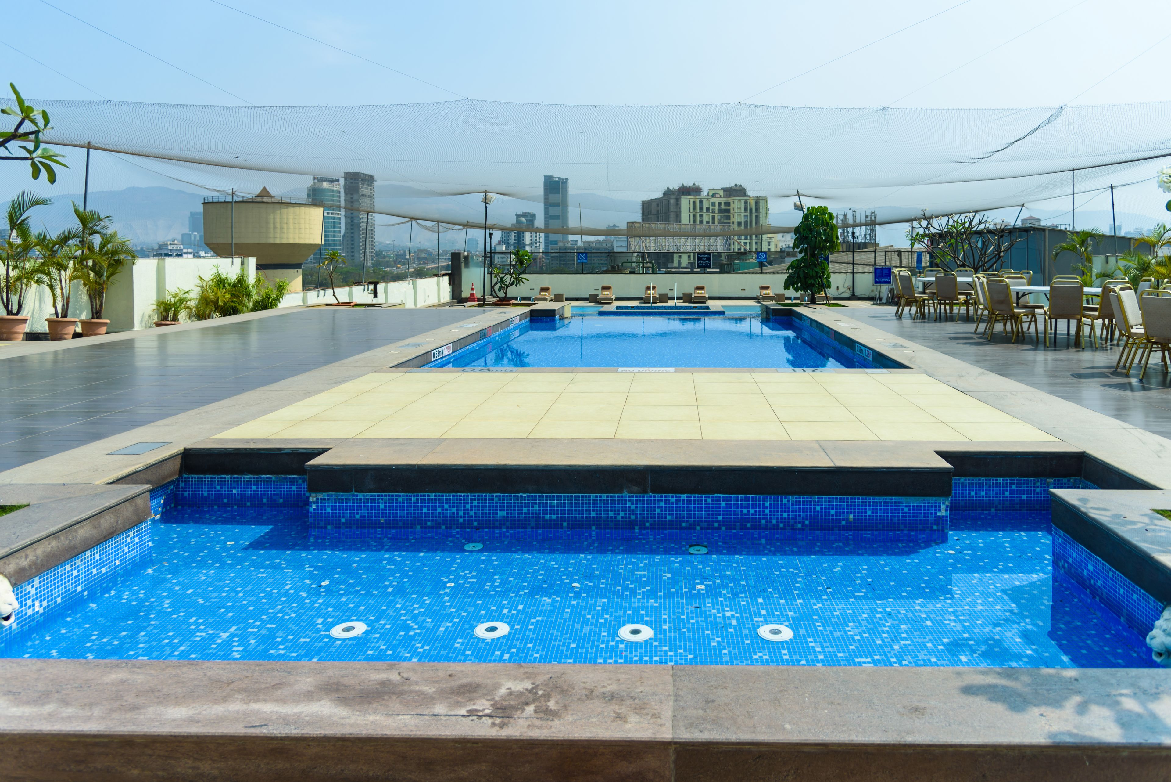 outdoor pool, open 7:00 am to 7:00 pm, pool loungers, lifeguards on site