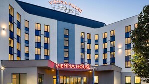 A modern hotel with a prominent sign reading "VIENNA HOUSE." - Vienna House Easy by Wyndham Bratislava (Bratislava)
