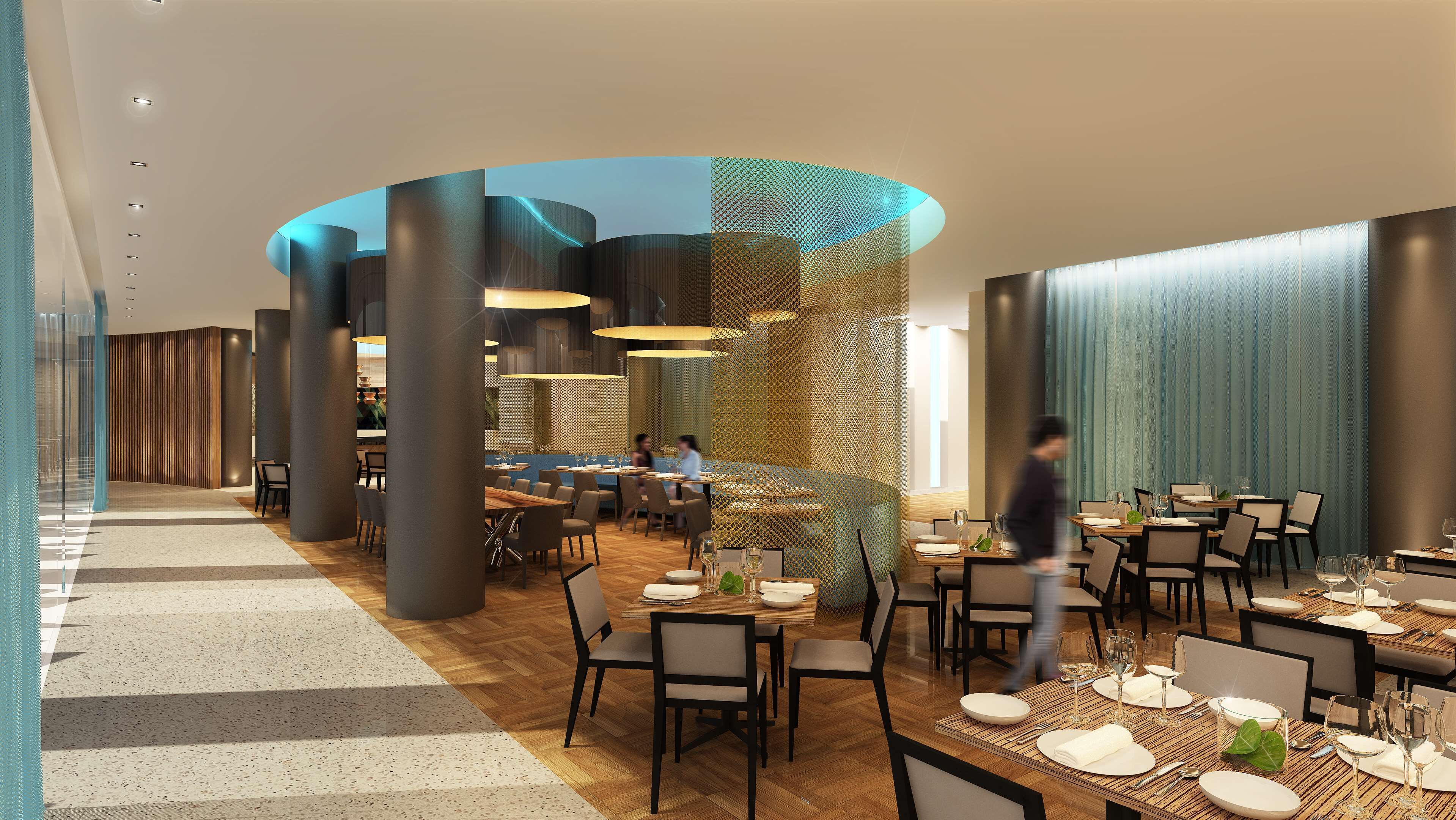 A modern restaurant interior with high ceilings, wooden flooring, and a mix of round and rectangular tables.