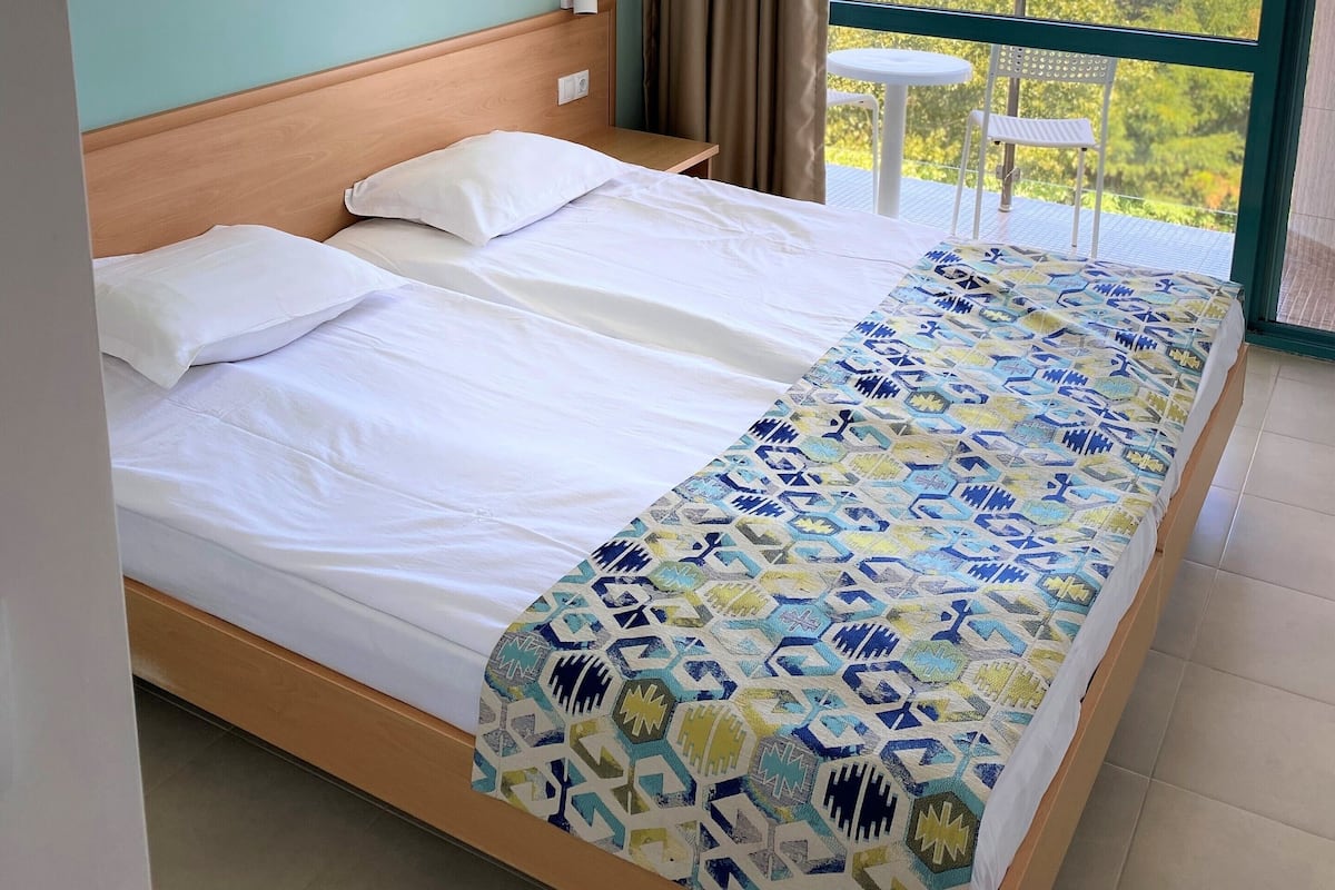 Desk, laptop workspace, blackout curtains, bed sheets