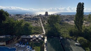 A resort with a swimming pool, lounge chairs, and a view of the sea. - Sirena Hotel (Sunny Beach)