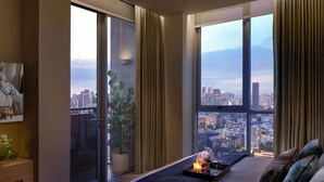 A modern bedroom with a large bed, a city view, a sliding door, and a small table with candles. - Somerset Sukhumvit Thonglor Bangkok (Bangkok)