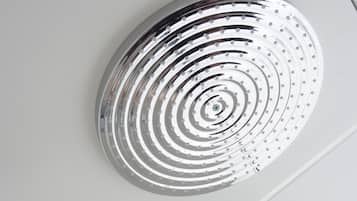 A modern showerhead with a circular design and a separate handheld shower attachment.