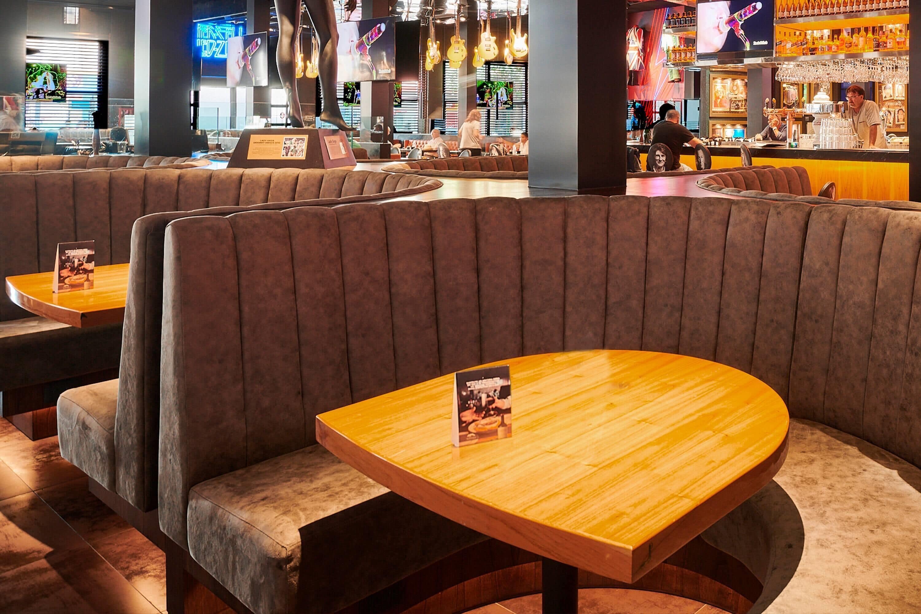 A restaurant with booth seating and wooden tables.