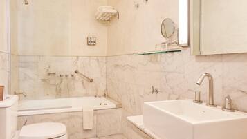 A modern bathroom with a bathtub, toilet, and sink.