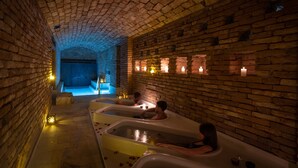 A spa area with brick walls and multiple hot tubs. - Azur Real Hotel Boutique & Spa (Córdoba)