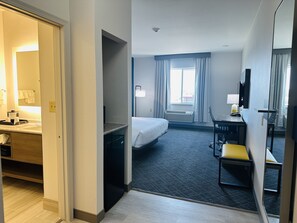 A hotel room with a bed, desk, chair, and a television. - Comfort Inn & Suites Wylie (Wylie)