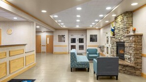 A lobby with a reception desk, seating area, and a stone fireplace. - Days Inn by Wyndham Chino Valley (Chino Valley)