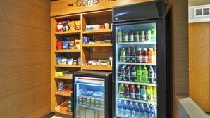 A corner market with shelves stocked with snacks and a refrigerated display case with beverages. - Fairfield Inn & Suites by Marriott Lexington North (Lexington)