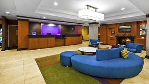 A modern lobby with a reception desk, seating area, and a fireplace. - Fairfield Inn & Suites by Marriott Lexington North (Lexington)