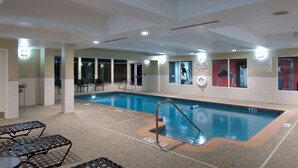 An indoor swimming pool with a diving board, lounge chairs, and a lifeguard sign. - Hilton Garden Inn Mount Holly/Westampton (Mount Holly)