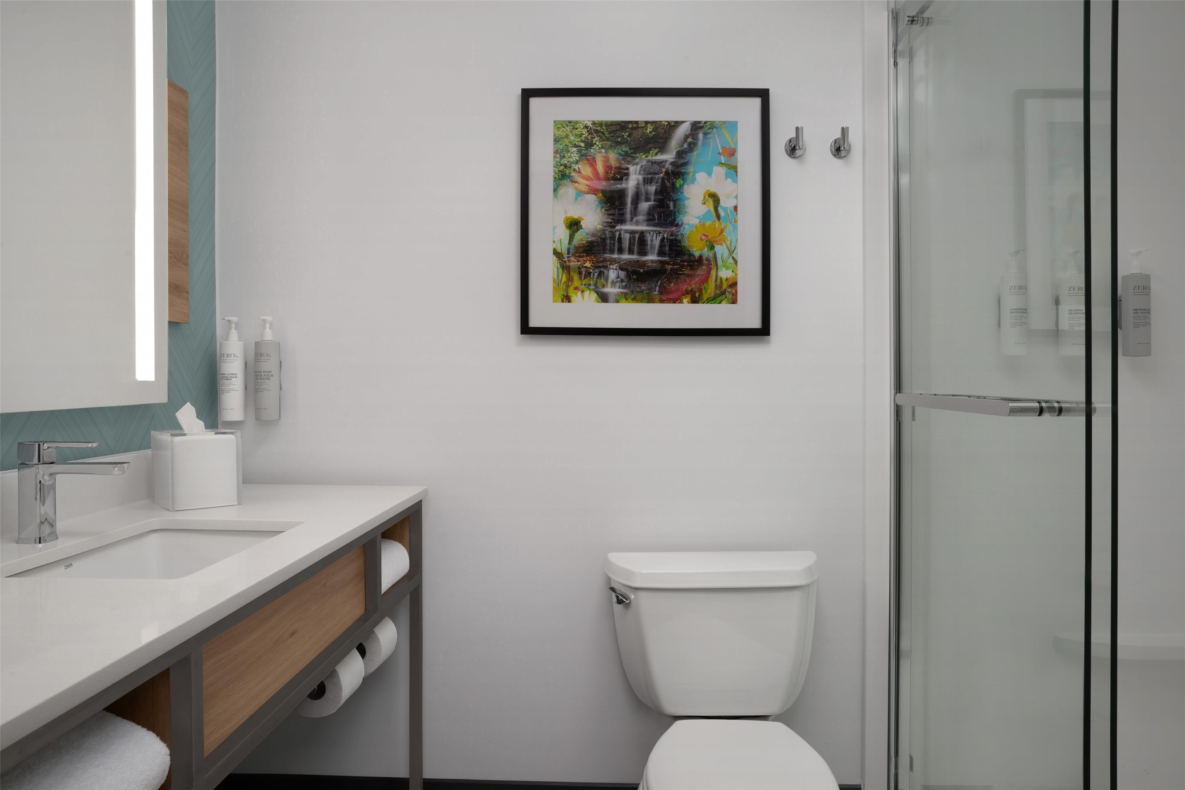 deep-soaking bathtub, rainfall showerhead, designer toiletries