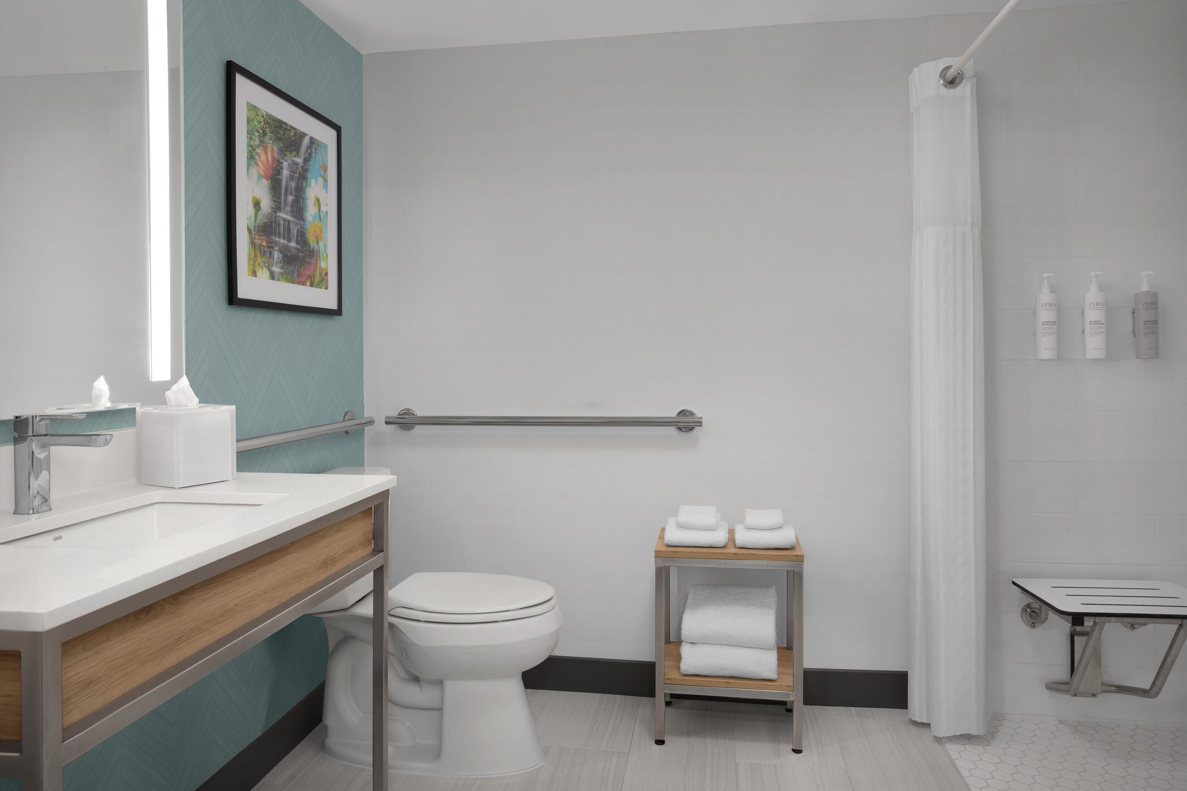 deep-soaking bathtub, rainfall showerhead, designer toiletries