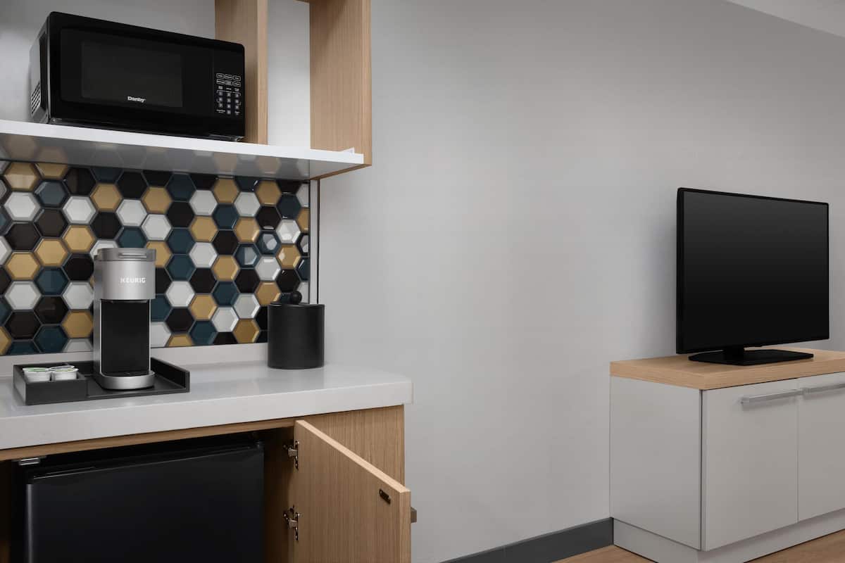 Premium bedding, desk, laptop workspace, iron/ironing board