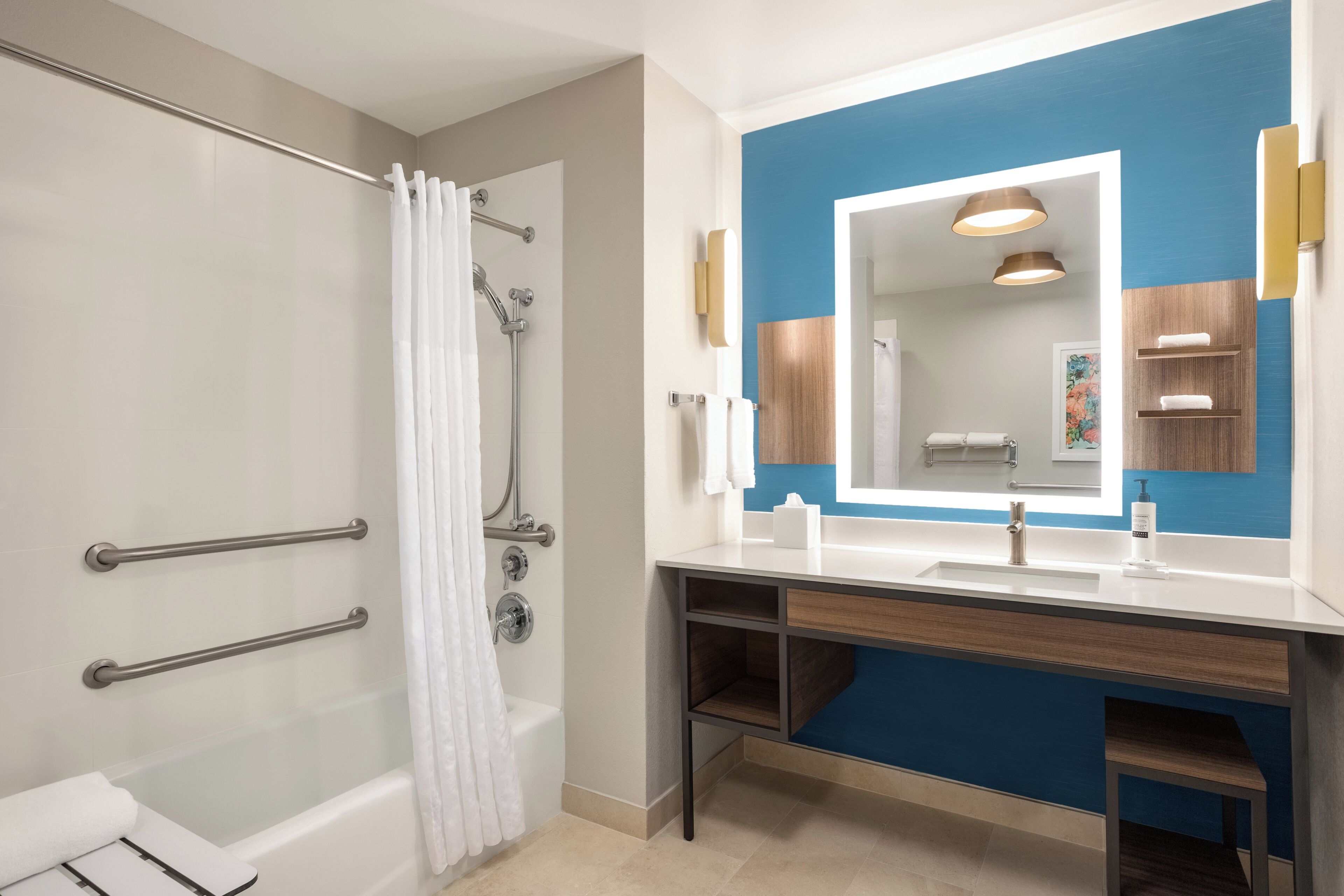 A modern bathroom with a shower, a vanity with a mirror, and a bathtub.