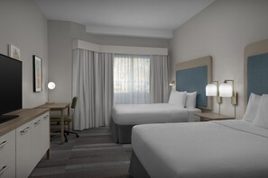 A hotel room with two beds, a desk, a chair, a TV, and a window with curtains. - Homewood Suites by Hilton Birmingham-SW-Riverchase-Galleria (Birmingham)