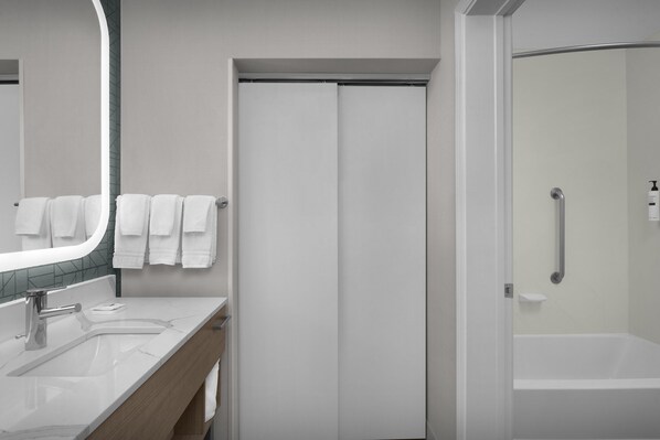 A modern bathroom with a white sink, mirror, and shower. - Homewood Suites by Hilton Birmingham-SW-Riverchase-Galleria (Birmingham)
