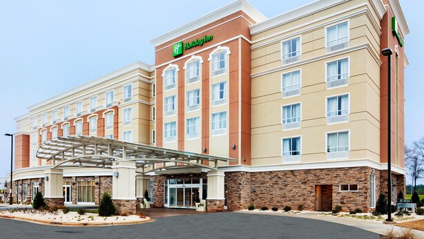 A Holiday Inn Express hotel with a modern facade, a covered entrance, and a parking lot. - Holiday Inn Rock Hill by IHG (Rock Hill)