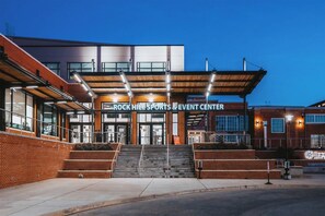 The exterior of the Rock Hill Sports & Event Center with a modern design, featuring a brick facade, large windows, and a covered entrance area. - Holiday Inn Rock Hill by IHG (Rock Hill)
