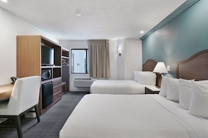 A hotel room with two beds, a desk, a microwave, a mini-fridge, a wardrobe, and a window with curtains. - Willow Creek Inn (Ephraim)