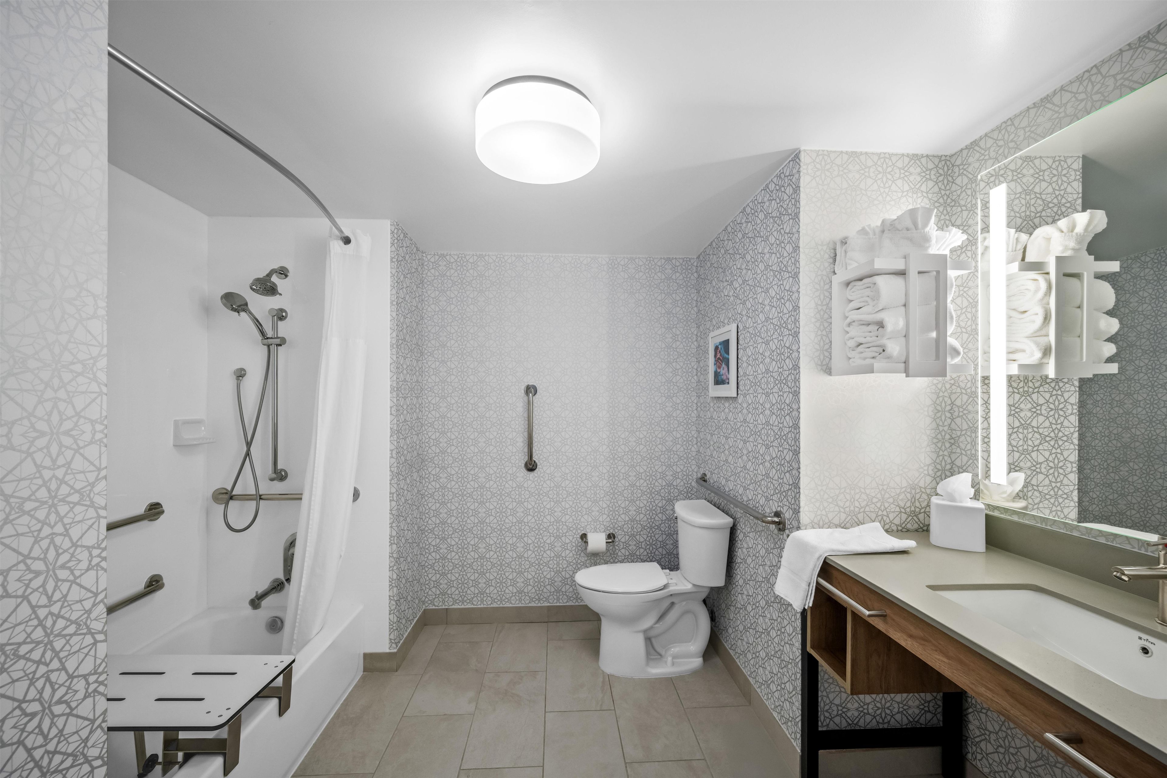 A modern bathroom with a shower, toilet, and sink area.