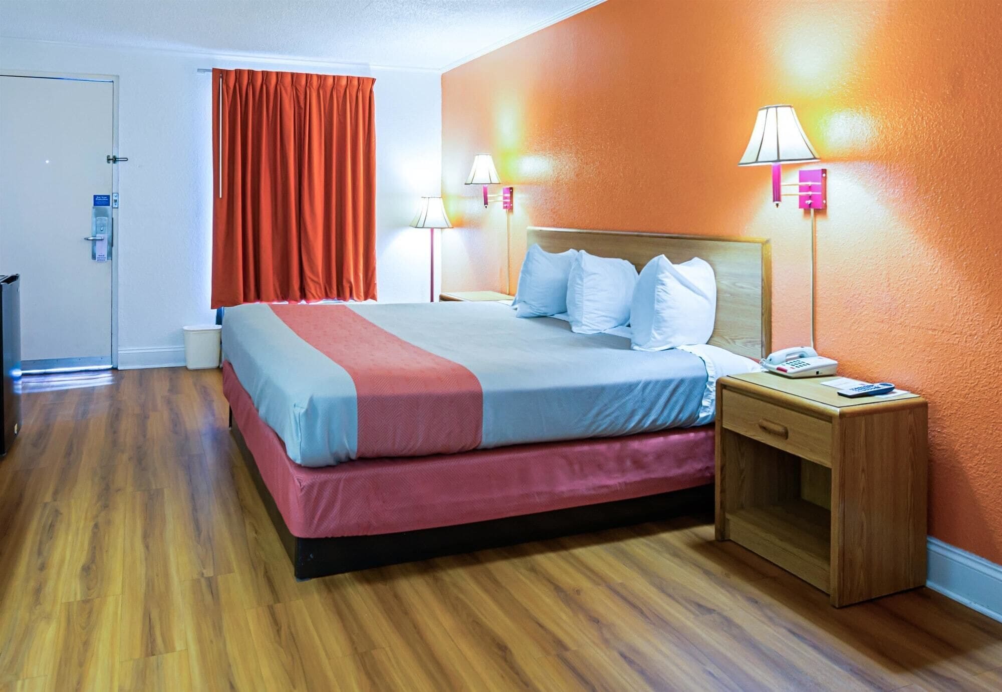 Ein Hotelzimmer mit Bett, Nachttisch und Beistelltisch.