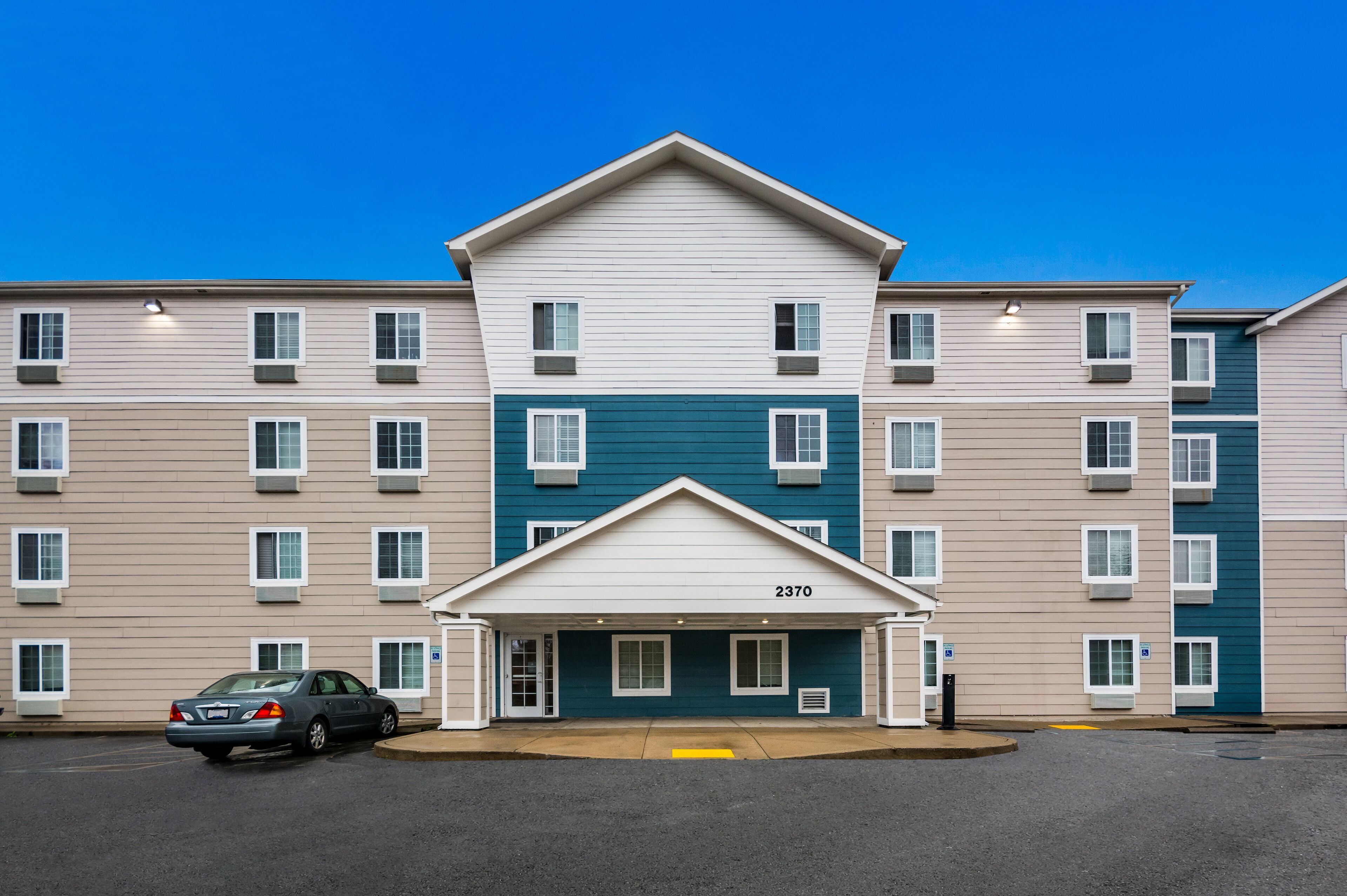 A multi-story apartment building with a central entrance marked by the number 2370.