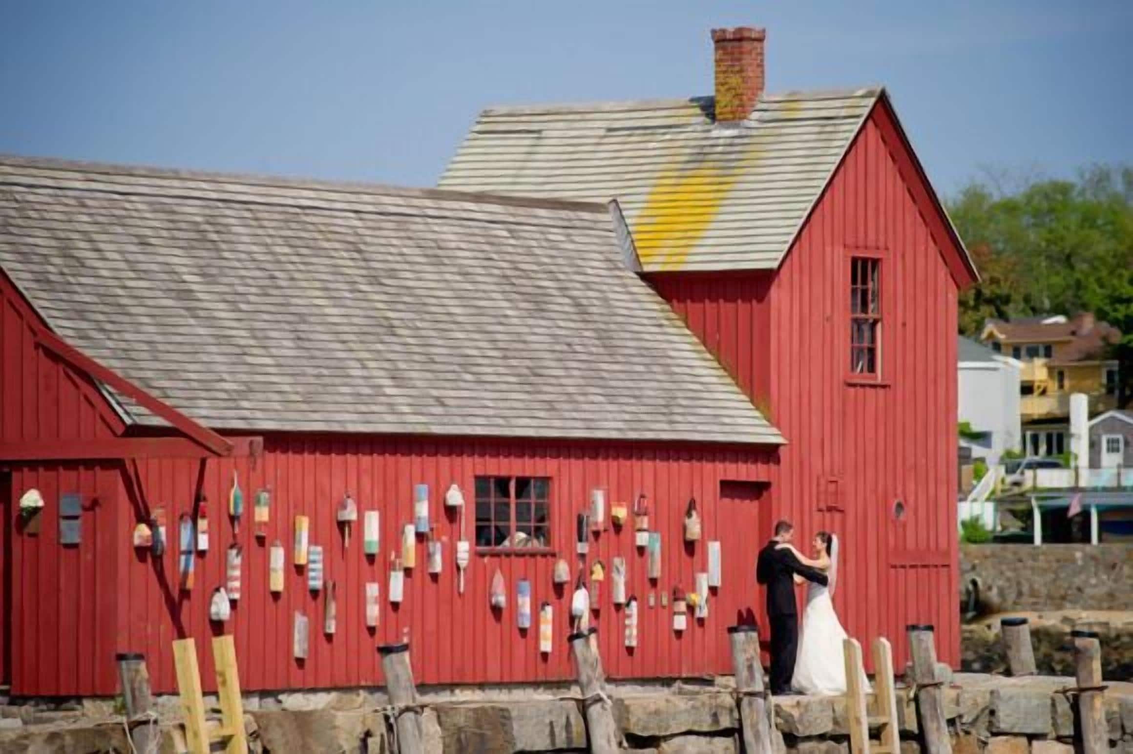 A red barn with a sloped roof and a chimney.