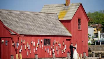 A red barn with a sloped roof and a chimney.