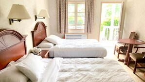 A hotel room with two beds, a desk, and a chair. - Lyn Aire Motel (Lake George)