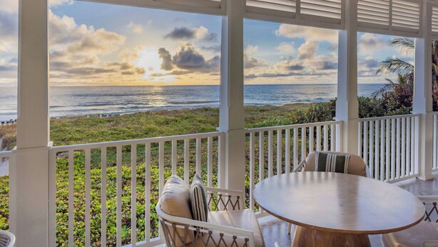 A covered outdoor seating area with a view of the ocean and beach. - The Seagate Hotel, Golf & Beach Club, Autograph Collection (Delray Beach)