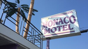 A sign for the Monaco Motel with a clear blue sky in the background. - Monaco Motel - Wildwood Beach & Boardwalk (Wildwood)