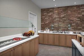 A modern kitchen with wooden cabinets, a glass shelf, and various food items. - Residence Inn Portland Downtown/Waterfront (Portland)