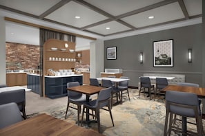 A modern hotel lobby with a bar area, seating arrangements, and a fireplace. - Residence Inn Portland Downtown/Waterfront (Portland)