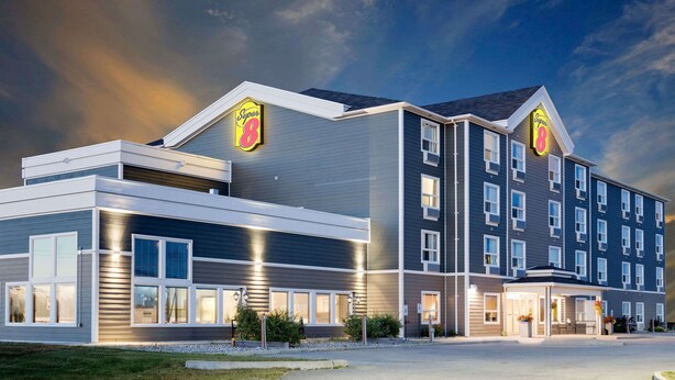 A modern hotel with a flat roof, multiple windows, and a prominent 'Super 8' sign. - Super 8 by Wyndham Kapuskasing (Kapuskasing)