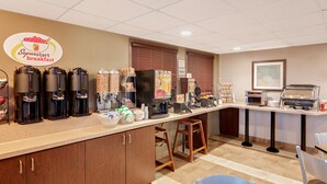 A breakfast bar with coffee machines, a refrigerator, and a sign for 'Superstart breakfast'. - Super 8 by Wyndham Kapuskasing (Kapuskasing)