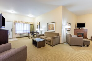 Suite, 1 King Bed | Living area | 32-inch flat-screen TV with cable channels, TV, DVD player