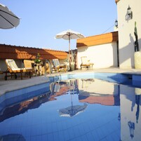 Una piscina al aire libre de temporada, sillones reclinables de piscina