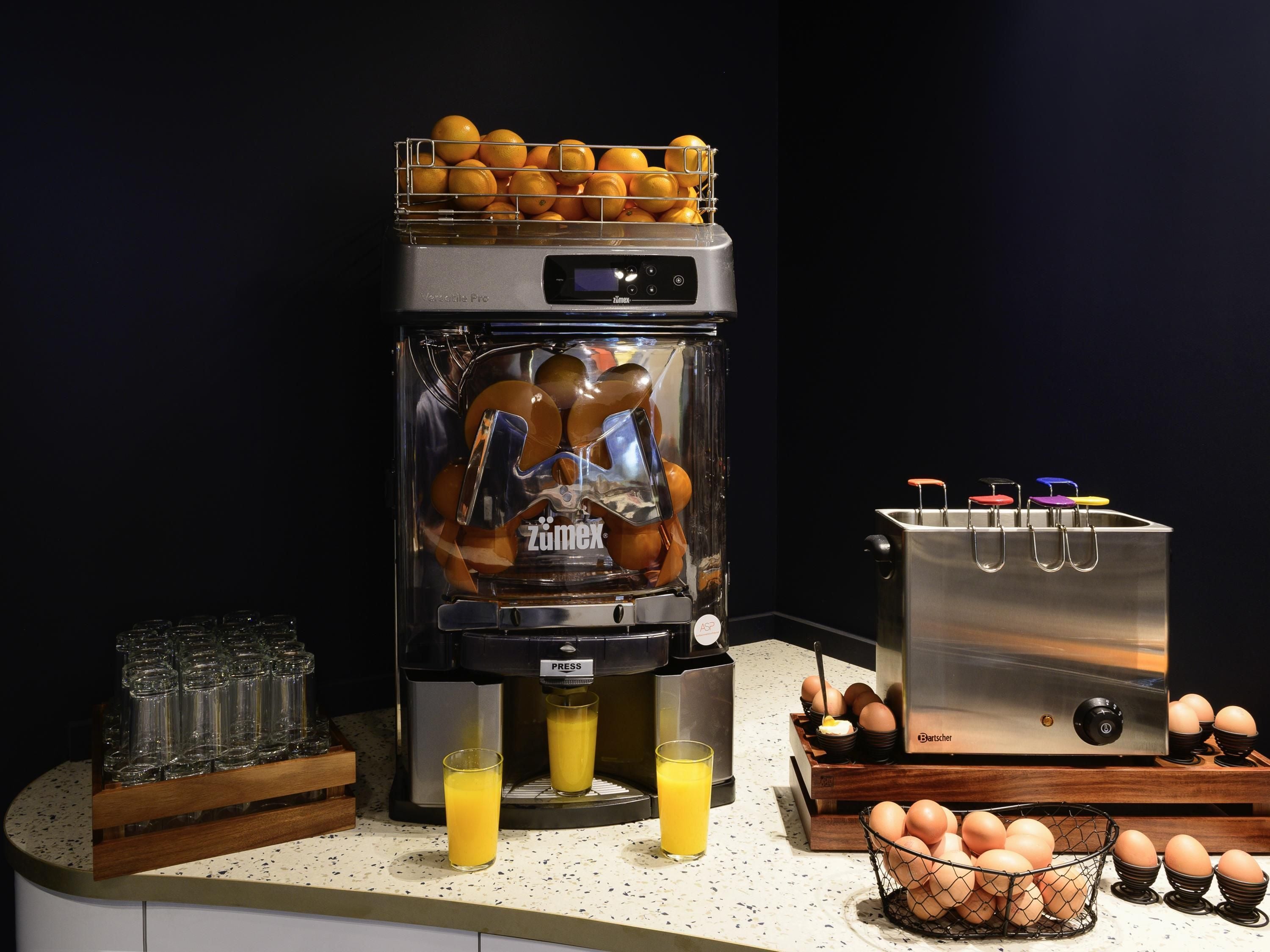 A kitchen with a juicer, toaster, and egg holder.